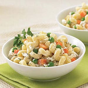 Two bowls of Boursin Garlic & Fine Herbs macaroni salad with olive oil, peas & carrots.